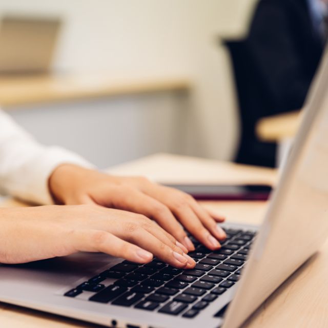 a person typing on a laptop